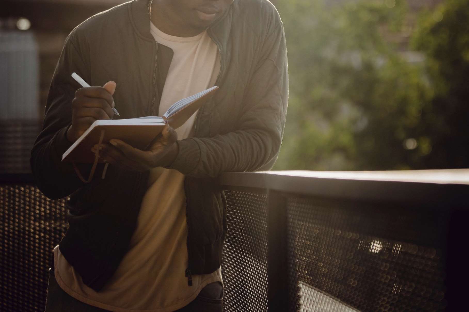 guy-writing-on-bridge